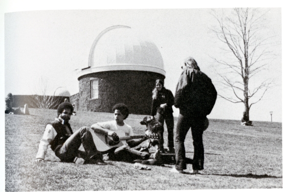 Students hanging out on Foss Hill. Observatory in background.