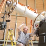 Fred Orthlieb demonstrates the motion of the telescope.